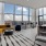 a room with a large window and a couch and chairs