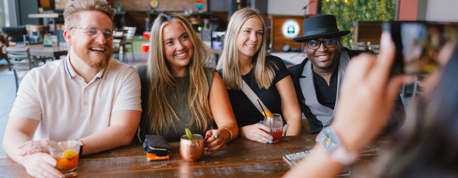 Four Friends taking a picture at local hot spot near by 