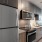a kitchen with a refrigerator and microwave