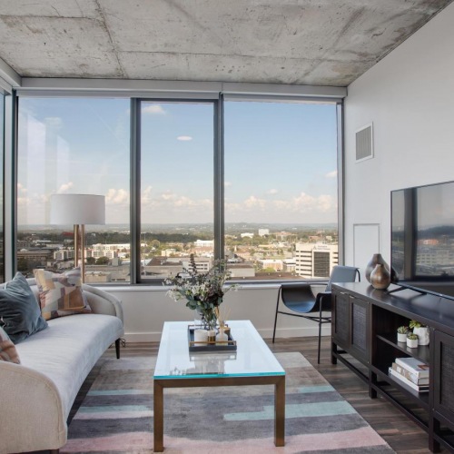 Generous living spaces with beautiful natural lighting a living room with a large window