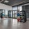 a room with exercise equipment and windows
