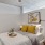 a bed with yellow pillows